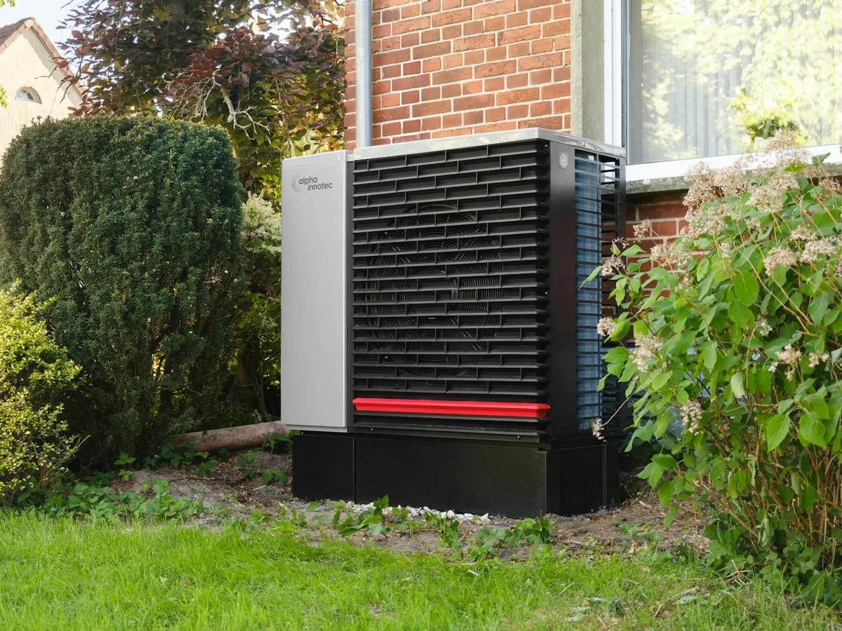 Cold-climate heat pump installed beside a house