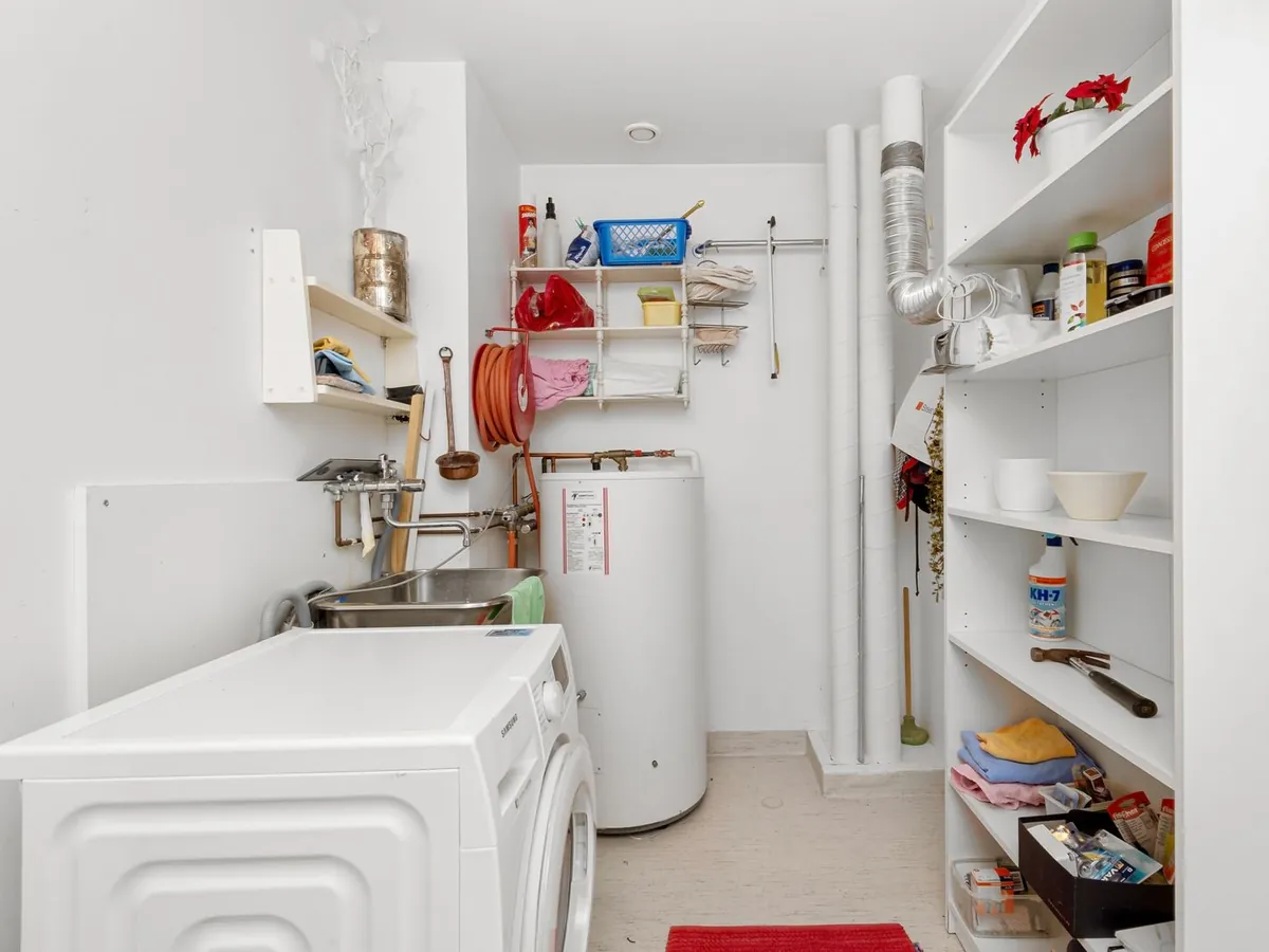 Tankless water heater installed on a utility room wall